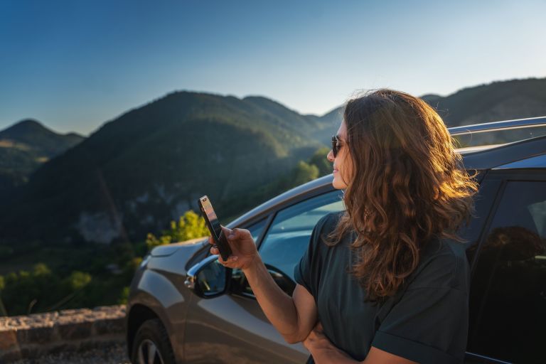 Snowy Mountains in background and lady with mobile phone