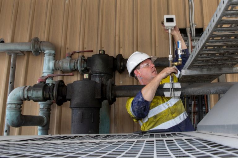 Worker inspecting electrical equipment, 