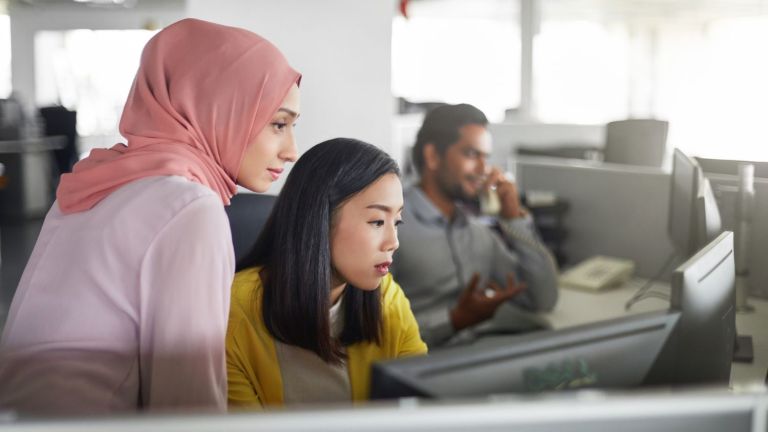 Two women working at a computer