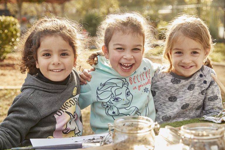 3 young children outside happy