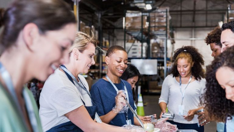 A group of diverse people help in a charity kitchen