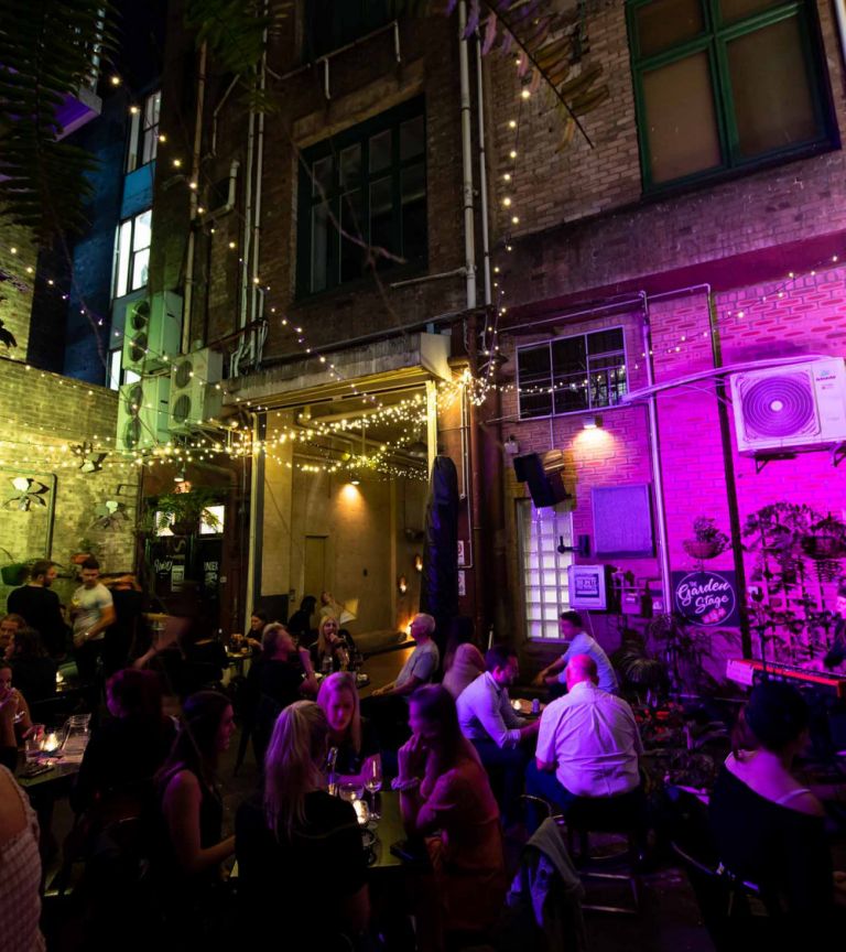 A courtyard venue packed with people at night.