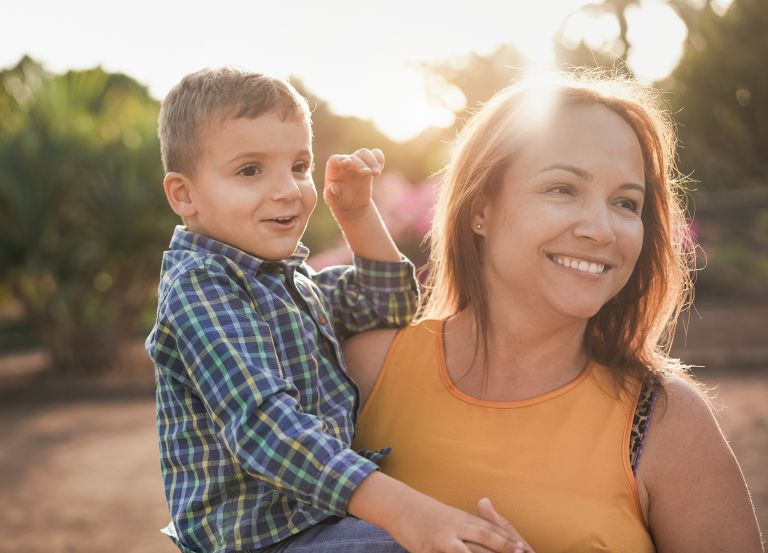 Lady holding child smiling 