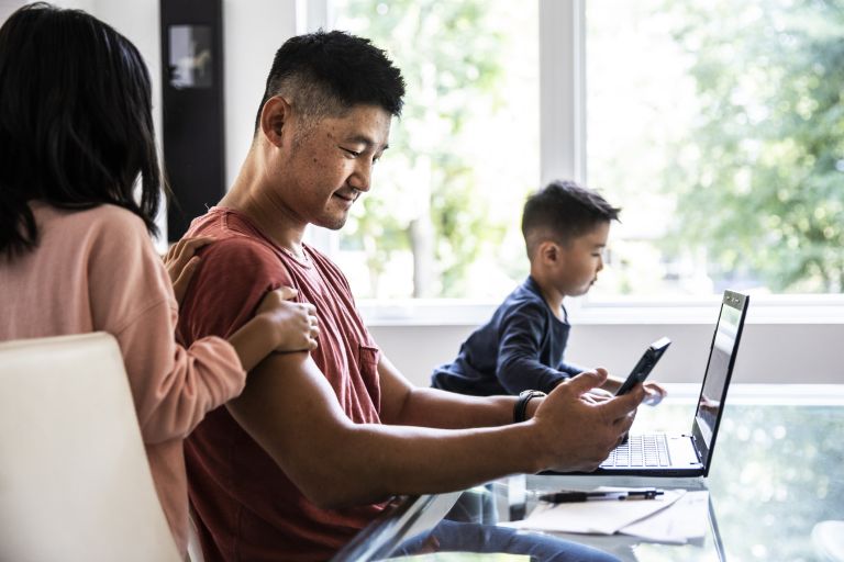 Father working at home with 2 children