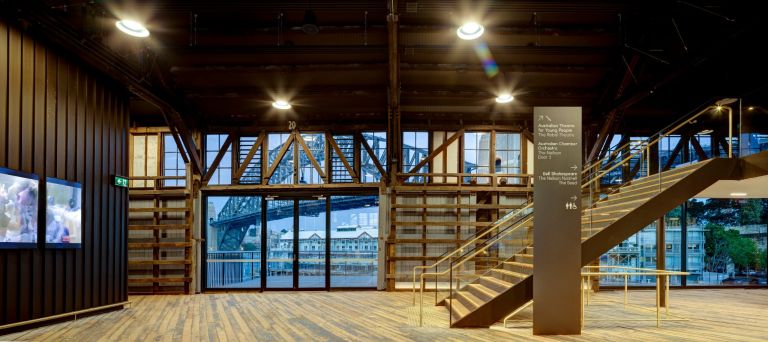 Wide well lit, widespaced foyer with Harbour Bridge peaking through windows