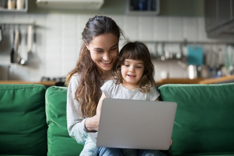 Mother and daughter using laptop