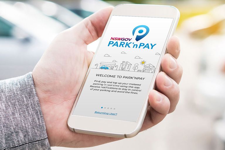 A person holds their smartphone in their hand, with the Park n Pay app open.