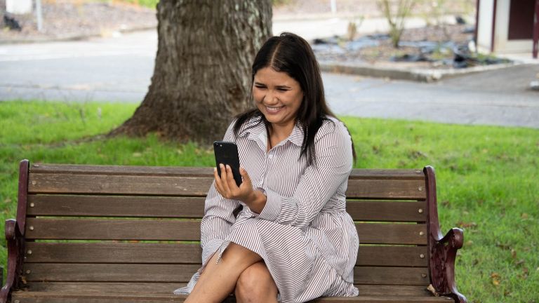 Leyesha looking at her phone