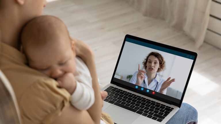 Mother with baby looking at a laptop