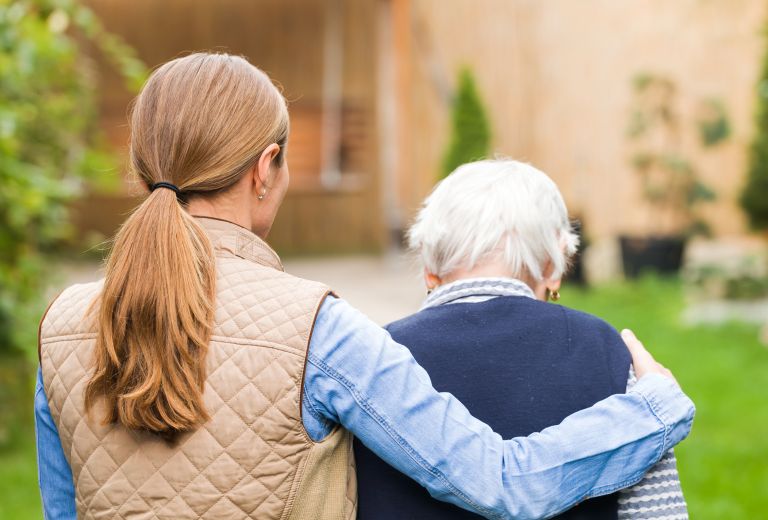 Palliative care volunteer offering support to a patient.