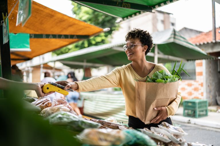 Woman shopping at outdoor market. 