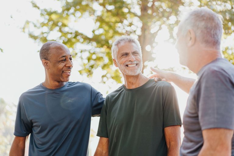 A group of men talking in a park