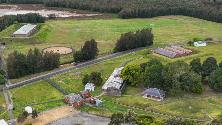 Aerial view of green landscape, heritage buildings and river