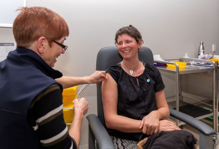 health professional giving vaccine to consumer