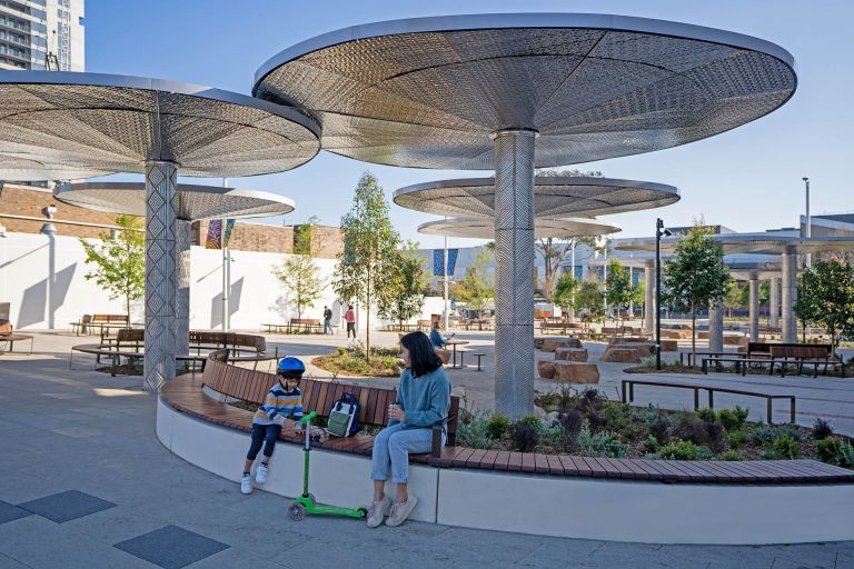 A parent and child using the smart furniture at Merrylands Civic Square. Credit: Cumberland City Council