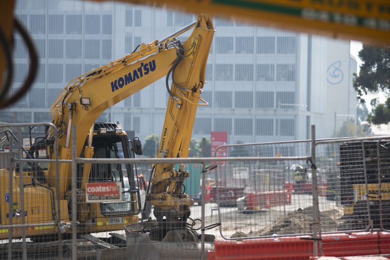 A daytime shot of an inactive crane in the middle of a construction site for the Parramatta Light Rail.