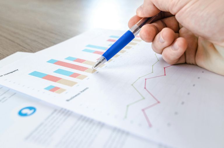 Pen pointing to charts