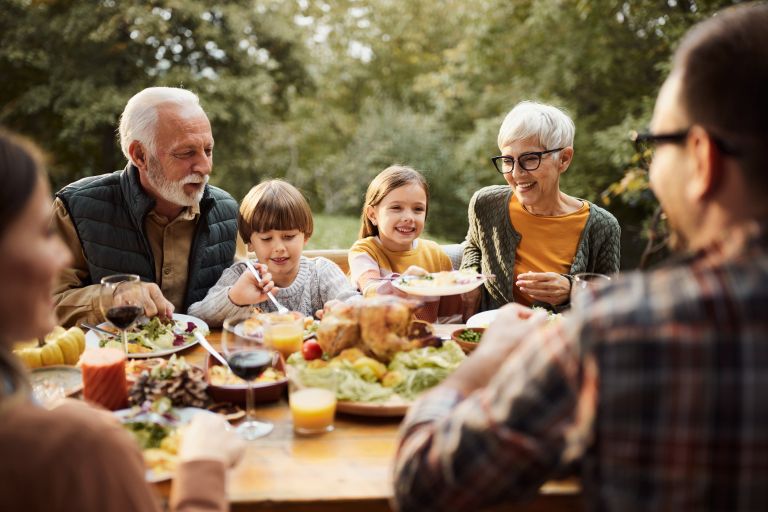 Family eats meal outside together