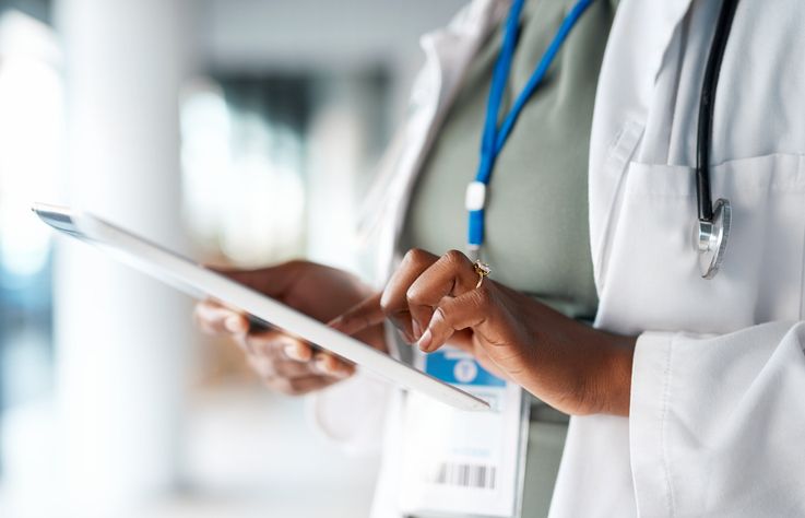 Image of doctor holding an electronic tablet