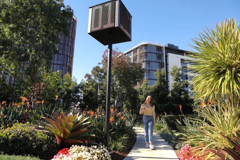 A pedestrian is strolling on a footpath that is equipped with environmental sensors to monitor the surroundings of Melrose Park.