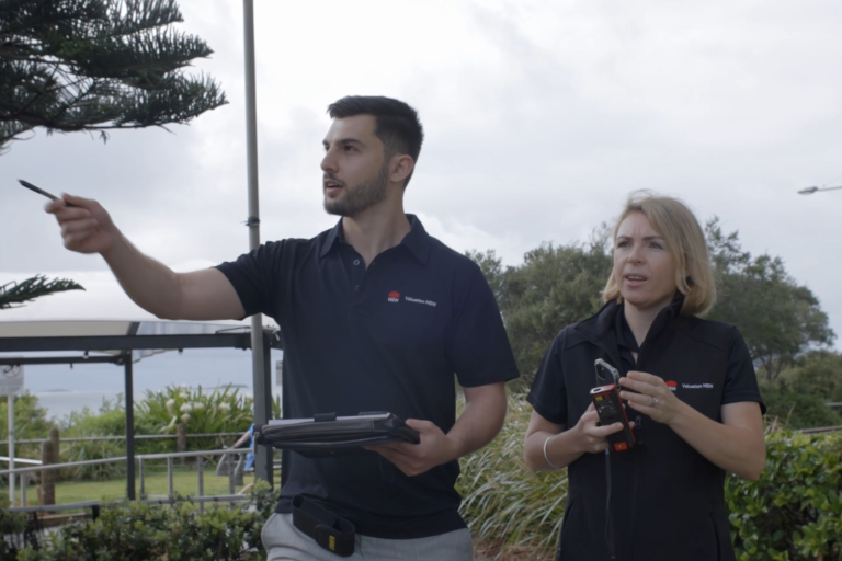 two valuers examining a property from afar