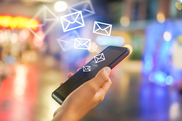 Woman hand using smartphone to send and recieve email.