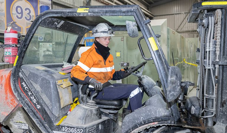 Female VET apprentice driving a tractor