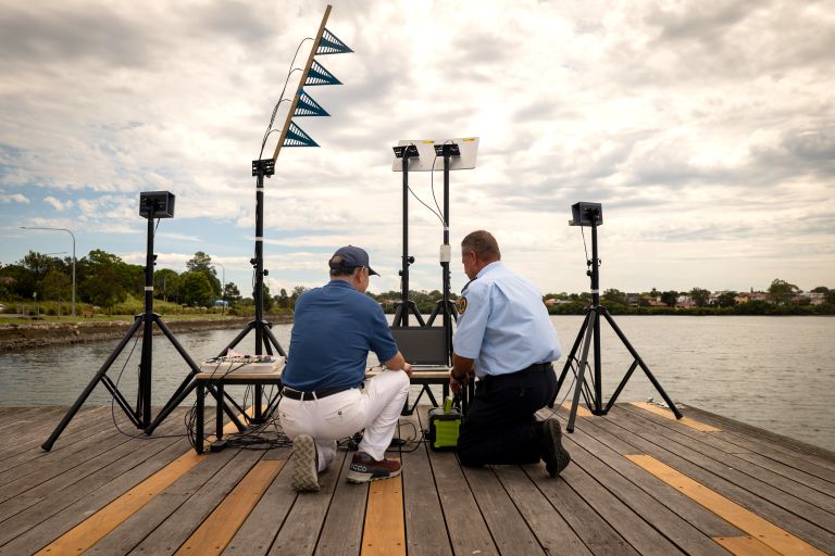 Two people from the NSW State Emergency Service and the University of Technology Sydney working with equipment together on the Flood and Storm Intelligence Sensing project.