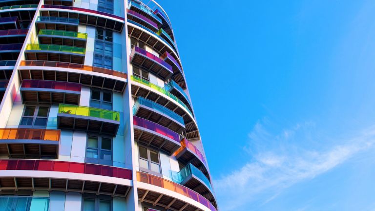 Modern colourful apartments and balconies with a blue sky