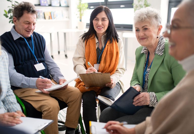 A group of committee members sitting in a meeting