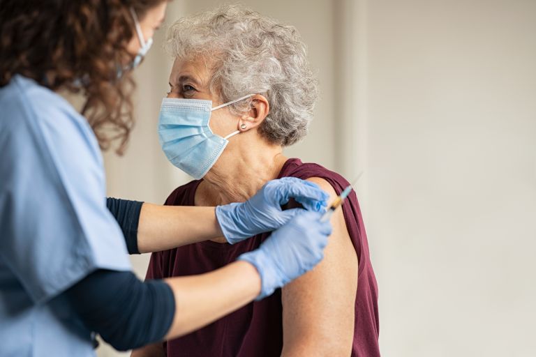 Elderly woman getting the COVID-19 vaccination