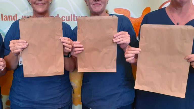 Nurses holding paper bags