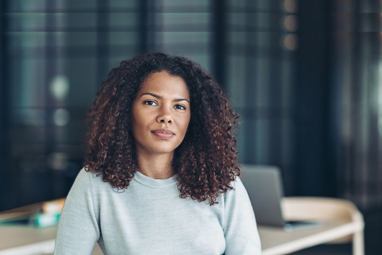 Female sitting at a table with a laptop. 