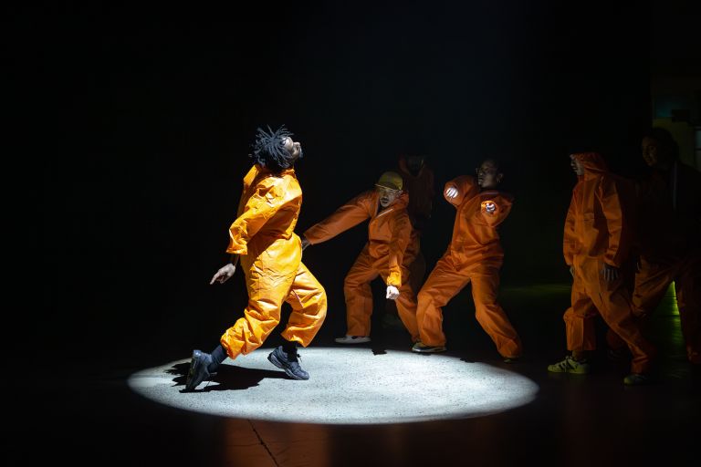 Male dancers performing in a spotlight at Carriageworks in Sydney