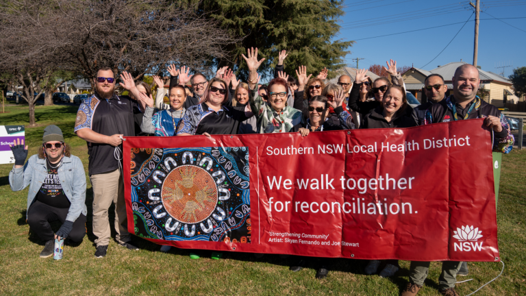Southern staff holding banner at Reconciliation Walk