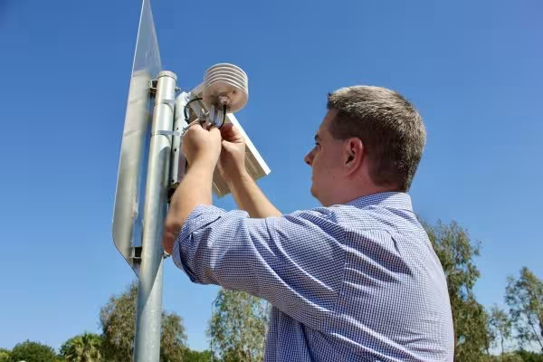  A man installing sensors on a street sign