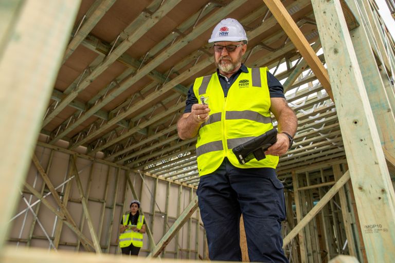 Person in high vis work wear on a construction site.