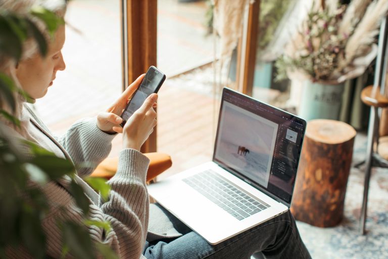 Girl on phone and laptop