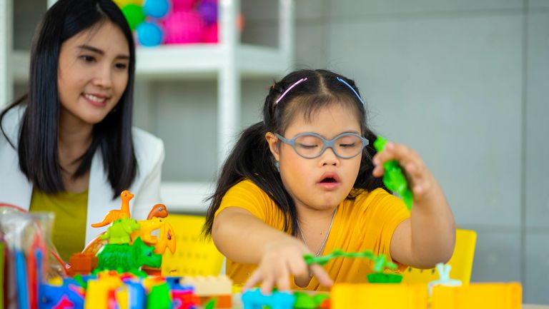 A young female paediatrician with her young patient