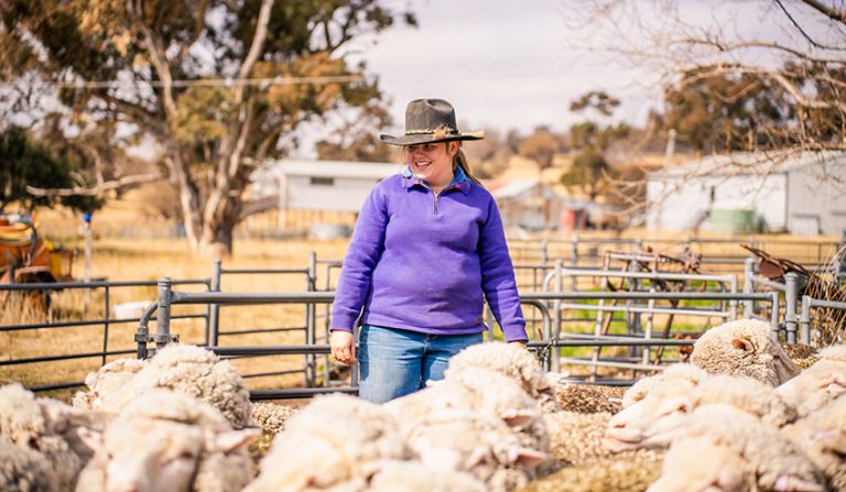 Female VET agriculture student outdoors with sheep