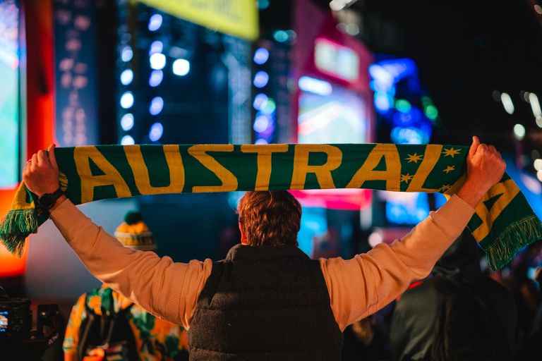 An Australia supporter holding a green and gold Australia scarf