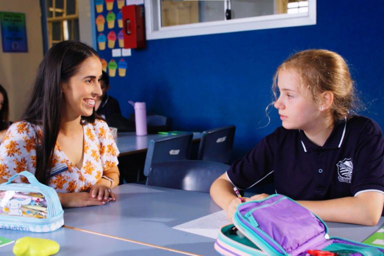 Image showing a teacher talking to a primary school student