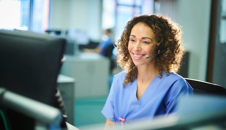 A female telehealth nurse speaking to a patient on the phone