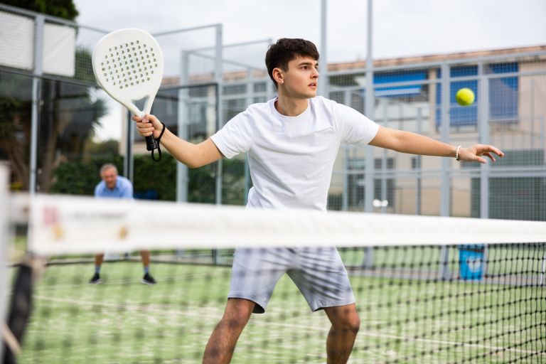 Home schooled sports child playing paddle tennis