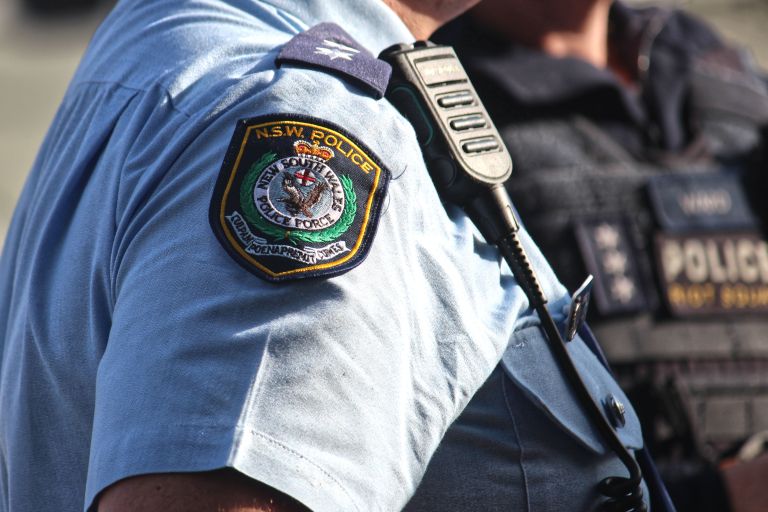 Close up shot of a NSW Police officer’s embroidered badge on his shoulder.