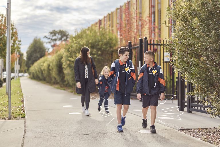 Primary students walking next to school