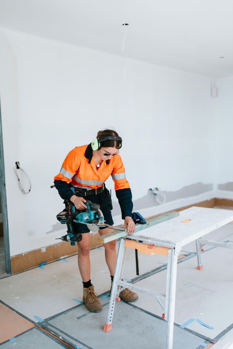 Ashlyn using a power saw