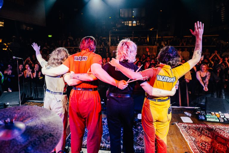 Band The Vacations take a bow after a performance on stage