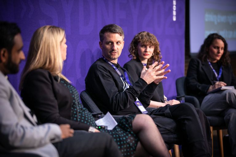 Person speaking in a panel at NEON Forum