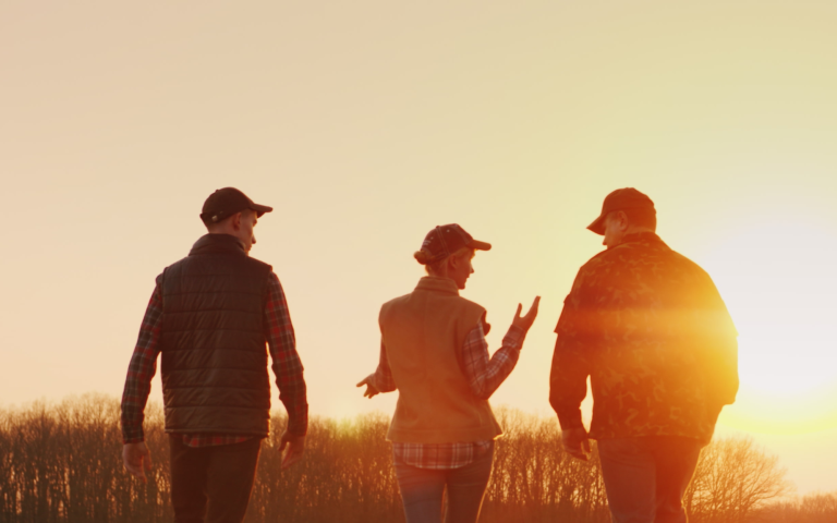 Volunteer workers walking together on farm